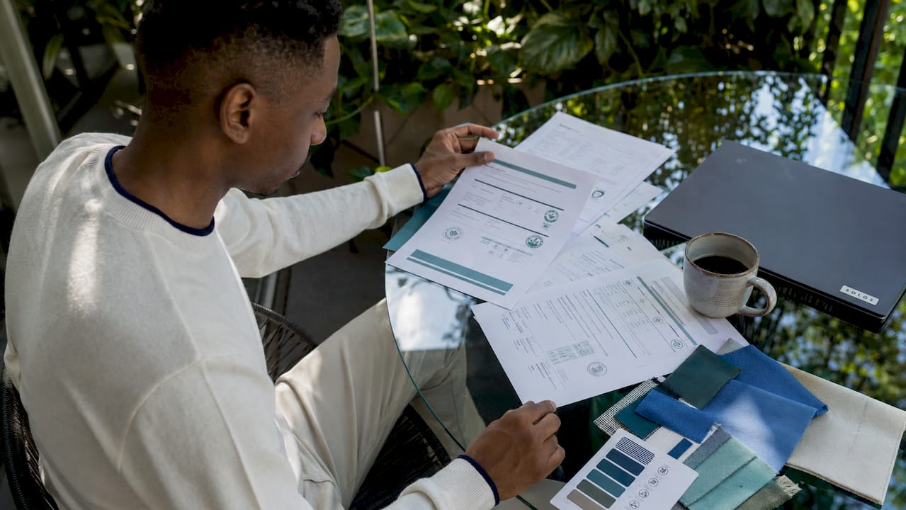 Person reviewing sustainable textile certifications at desk